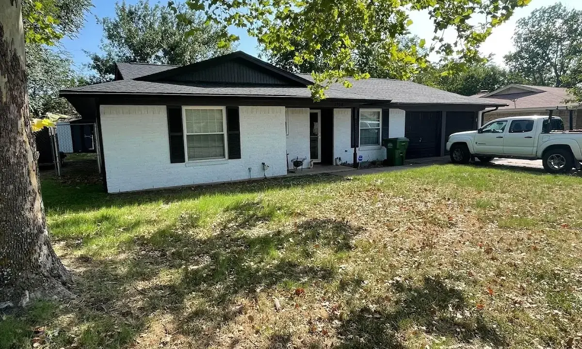 Professional roofing crew working on a residential roof in Kingsford